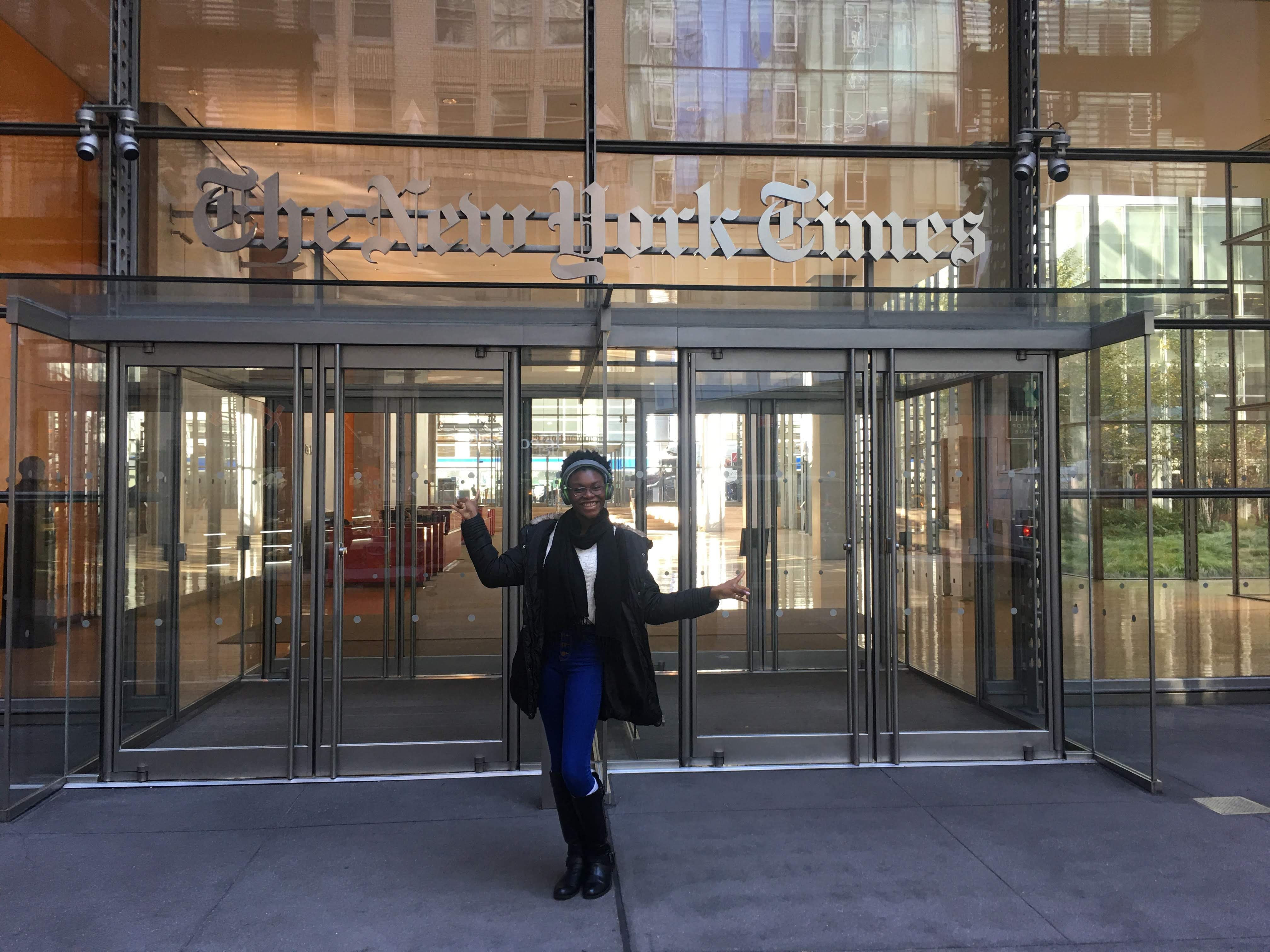 Deborah Afolabi, poses in front of the New York Times building in NYC.