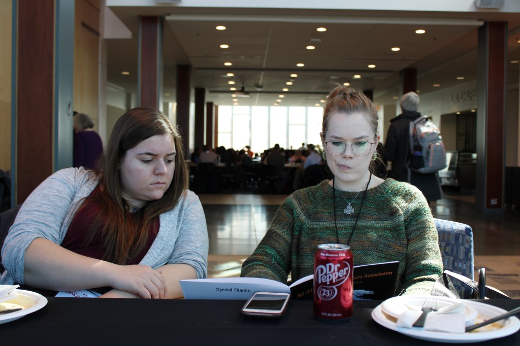 Two of Albright's writing center tutors decide which sessions to attend.