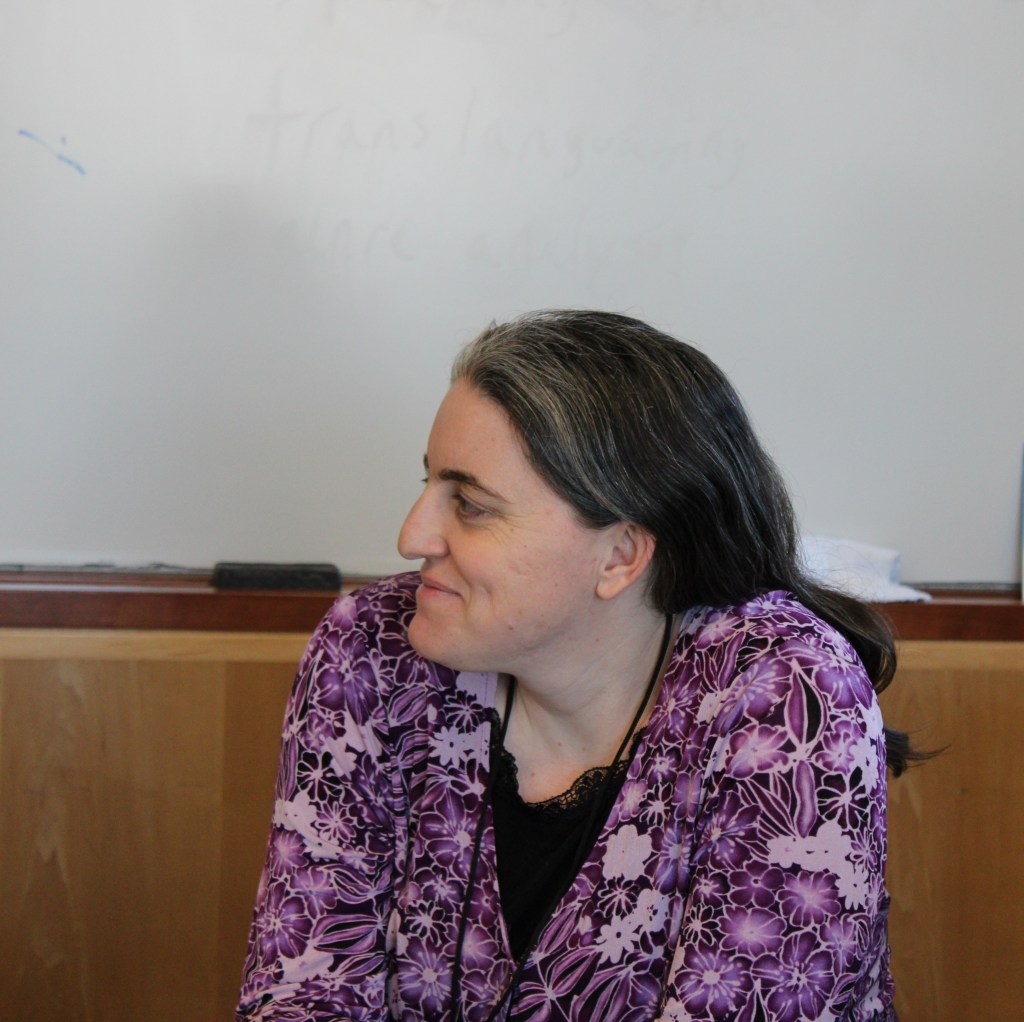 The director of the Albright writing center looks on as her tutors prepare for their panel.